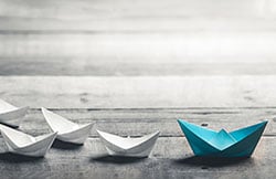 Paper boats in a row