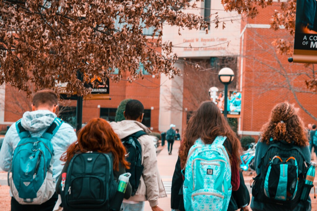 4 students walking on campus