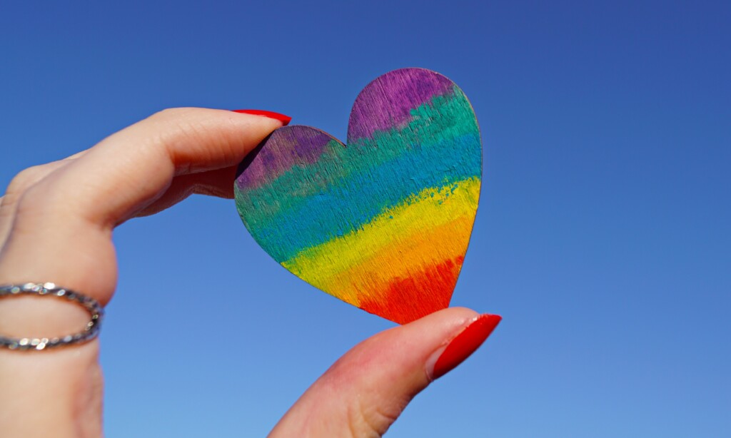 Rainbow heart held up in the sky