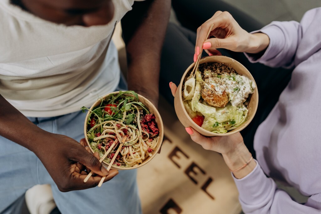 Two people eating bowls of food