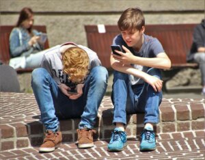 Teenage boys looking and phones